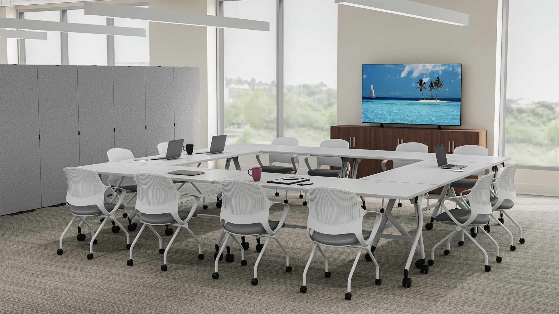 Shared meeting space outfitted with various UPLIFT Desk business solutions including Flip top tables and Rollaway nesting chairs