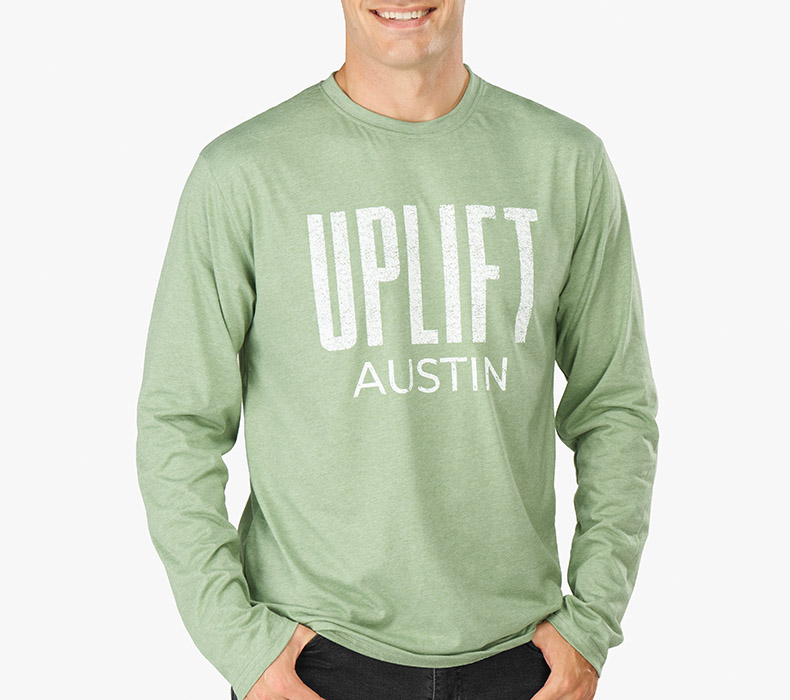 Front view of a person wearing a heather green Austin Long Sleeve T-Shirt