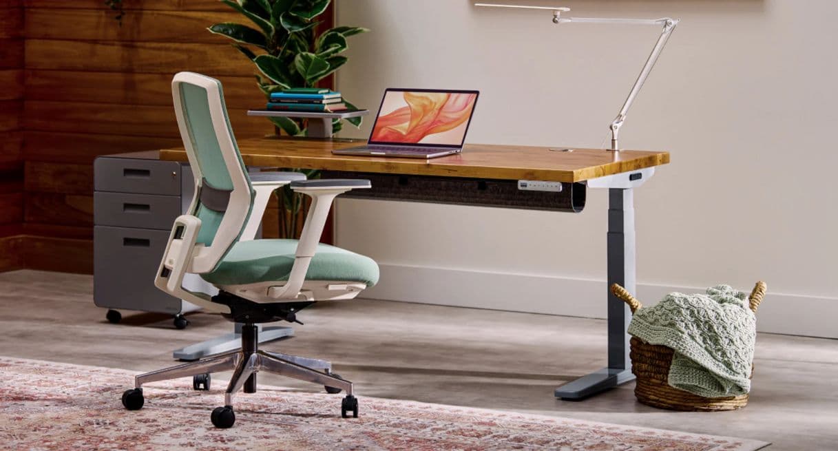 UPLIFT standing desk featuring various accessories and ergonomic products