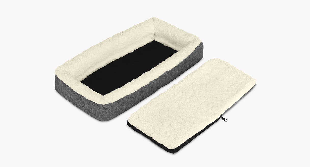 The breathable and durable white synthetic wool lining with gray stone-washed fabric exterior of a Pet Bed