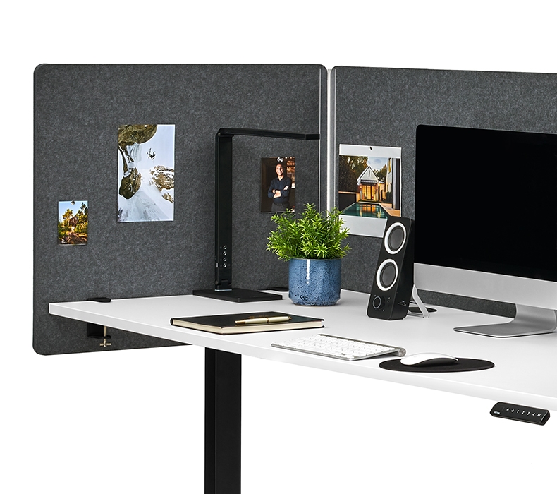 Close-up of a side panel of the 3-Sided Tall Acoustic Privacy Screen with photos tacked onto it