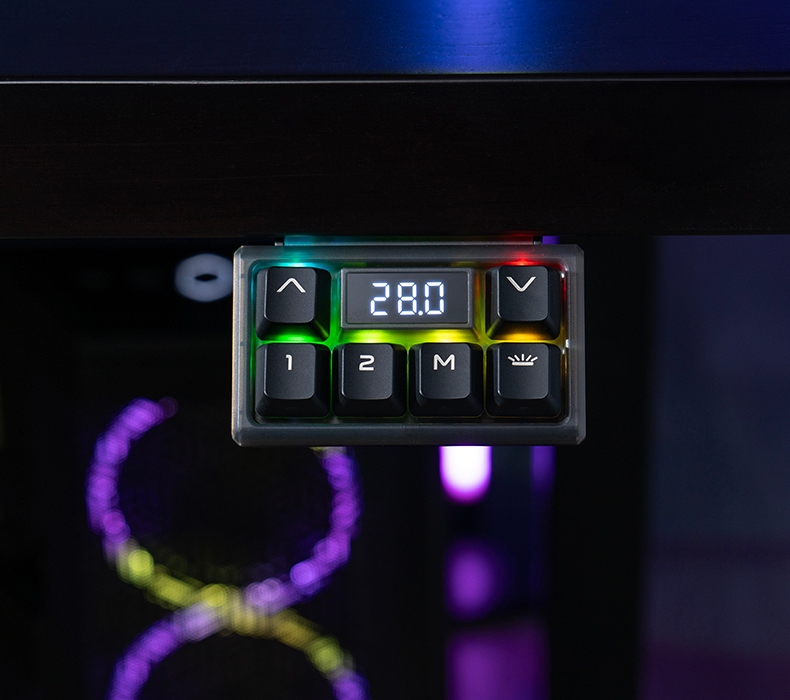 A black RGB Gaming keypad lit up in a variety of colors and mounted to a black bamboo desktop with a black V2 frame