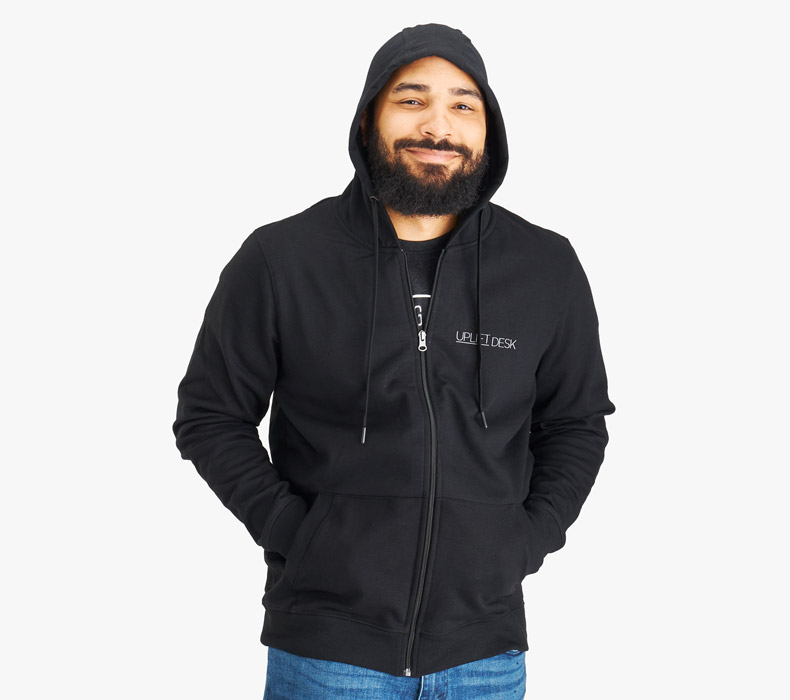 A person wearing a black UPLIFT Desk Full Zip Hoodie with the hood over his head