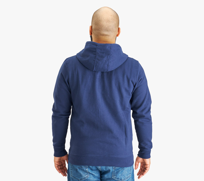 A reverse view of a person wearing a navy UPLIFT Desk Full Zip Hoodie