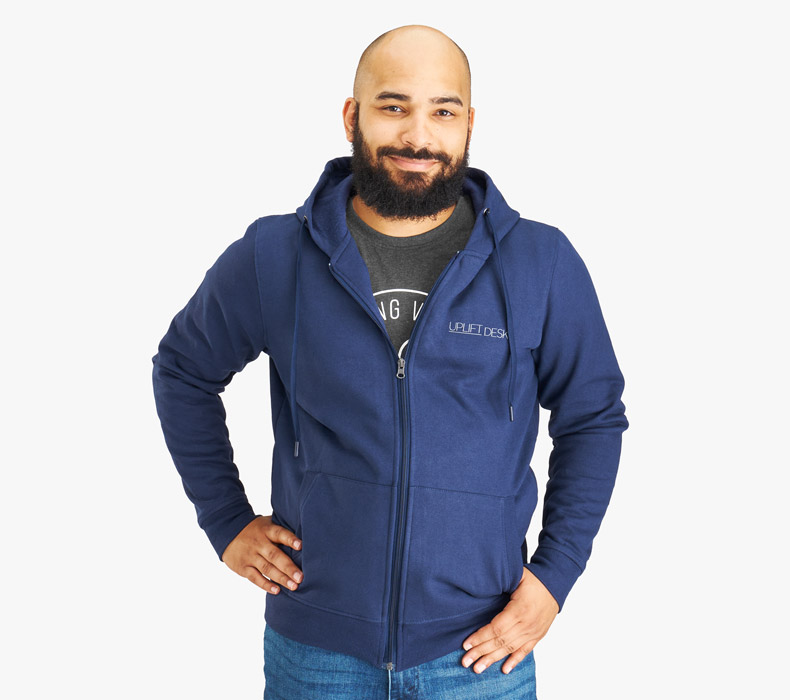 A person wearing a navy UPLIFT Desk Full Zip Hoodie