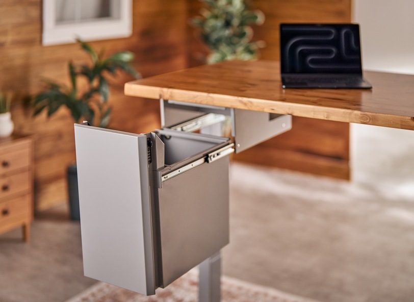 Gray Deep Desk Drawer installed underneath an UPLIFT Desk, showing seamless integration and added storage space.