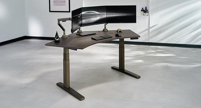 UPLIFT 120-degree standing desk with dark laminate top and industrial frame. Professional ergonomic setup