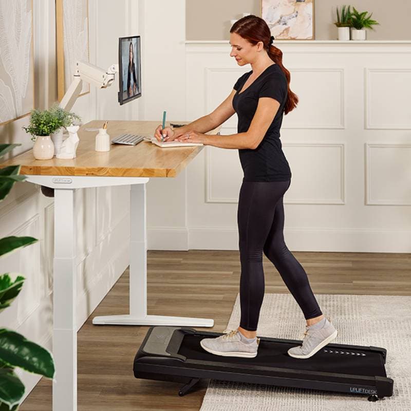 Active home office worker walking using the Inclining Walking Pad by UPLIFT Desk