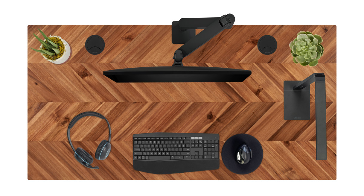 Acacia chevron solid wood desktop with black desk accessories.
