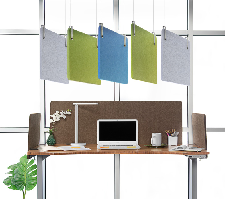 Five acoustic panels hang from the ceiling, and three acoustic panels mount to a standing desk below