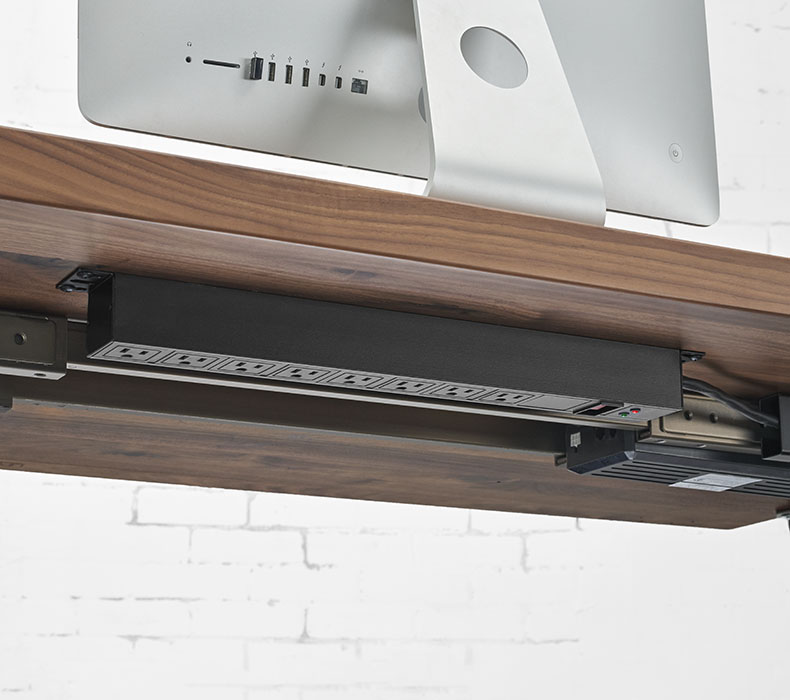 Surge Protector mounted to a desktop with downward-facing outlets