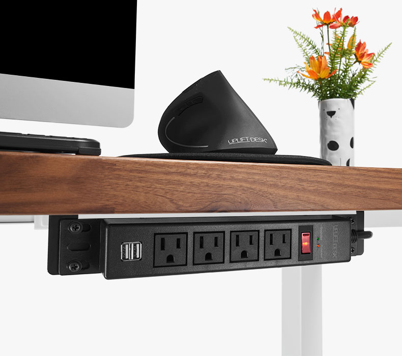 A 4-Outlet Mountable Surge Protect attached to a Walnut Solid Wood UPLIFT Sit Stand Desk
