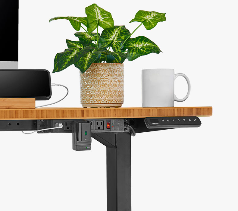 A 4-Outlet Mountable Surge Protector mounted to a Bamboo UPLIFT Standing Desk
