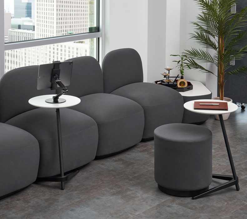 The Dillo side table shown with office lounge furniture functioning as an accent and C table