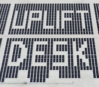 UPLIFT Desk warehouse solar panels spelling out the company name