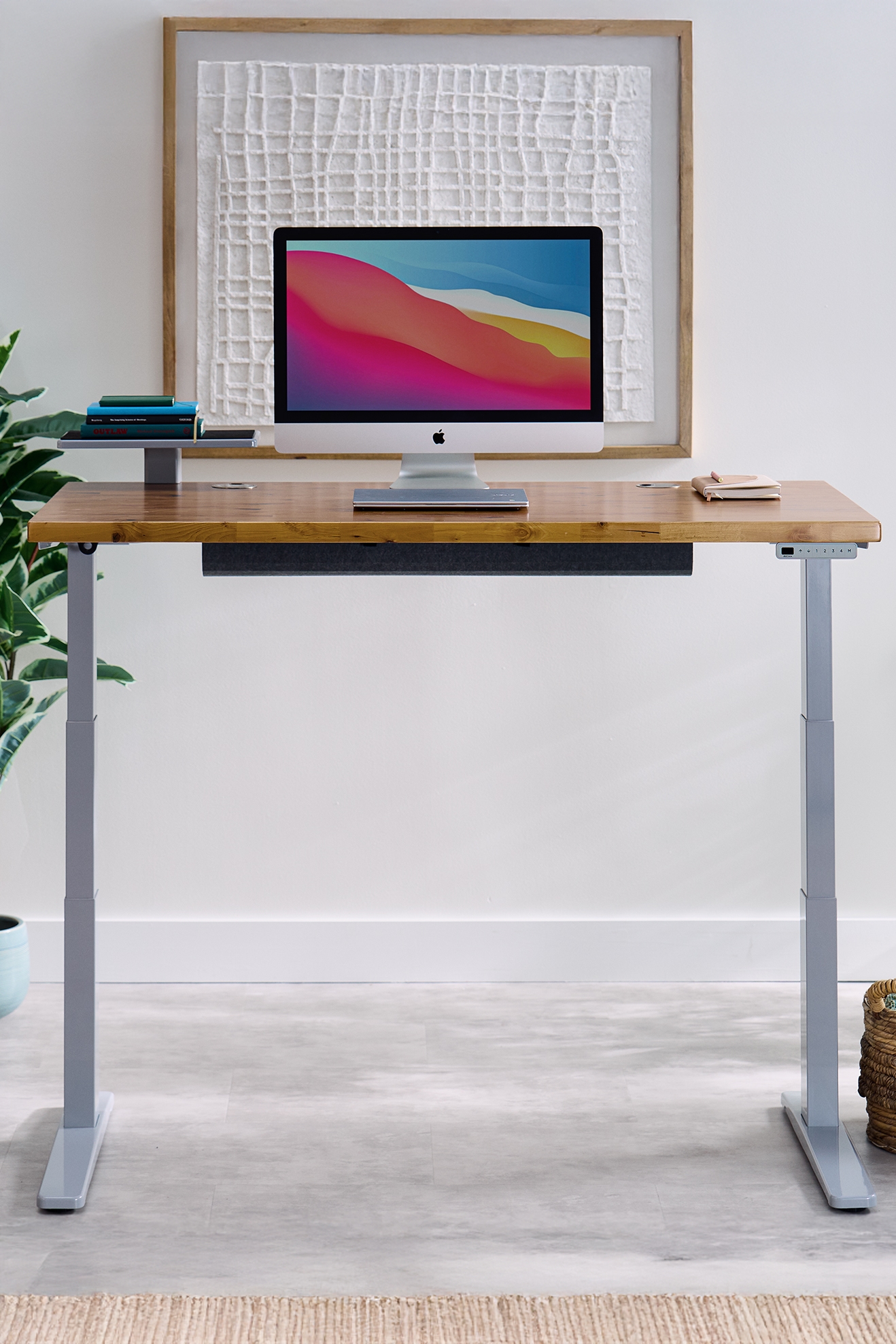 UPLIFT Standing Desk featuring a white 2-leg frame with a walnut laminate desktop.