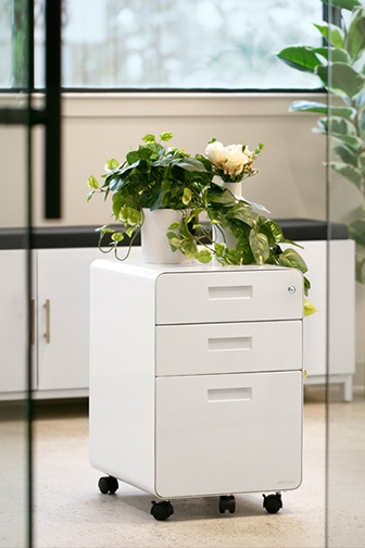 3-Drawer File Cabinet by UPLIFT Desk in white shown in an office setting.