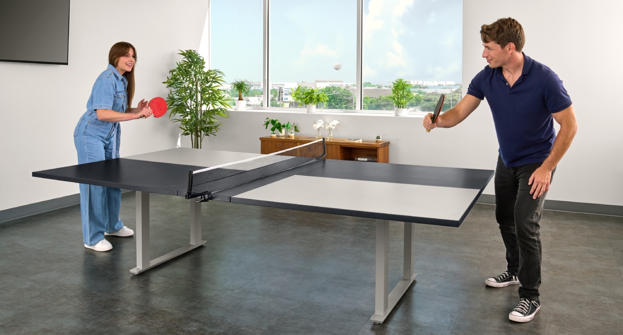 Seated Height Conference Table set up for table tennis in an office space with people playing